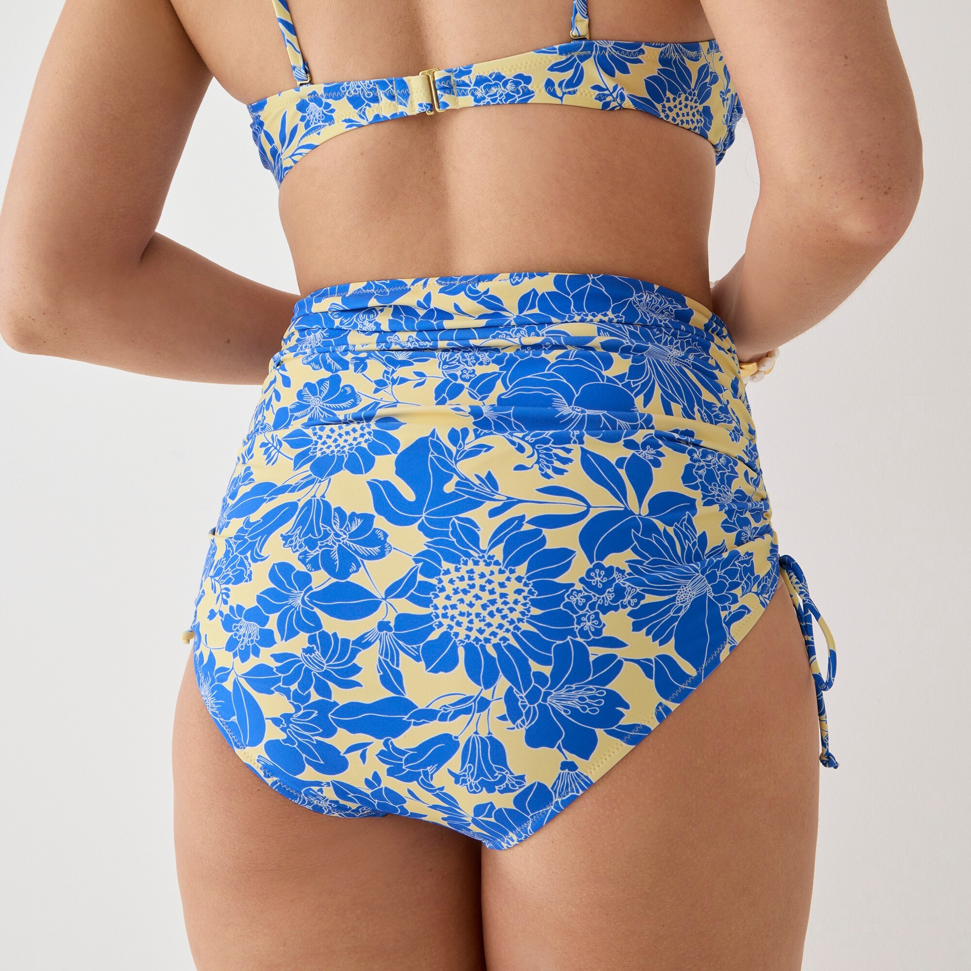 Ruched high-rise bikini bottom with side ties in blue floral