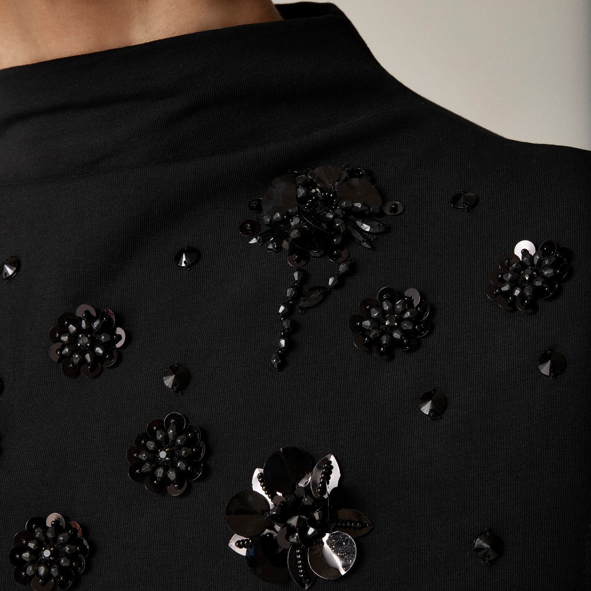 Stretch cotton-blend mockneck with floral embellishment