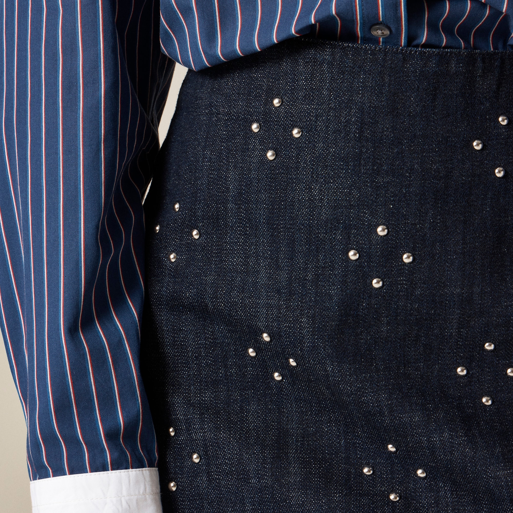 Mini denim skirt with stud embellishments