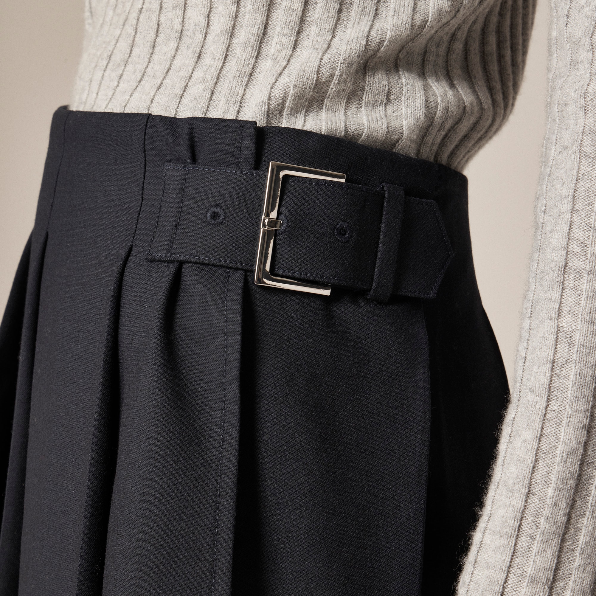 Pleated mini skirt with buckle detail