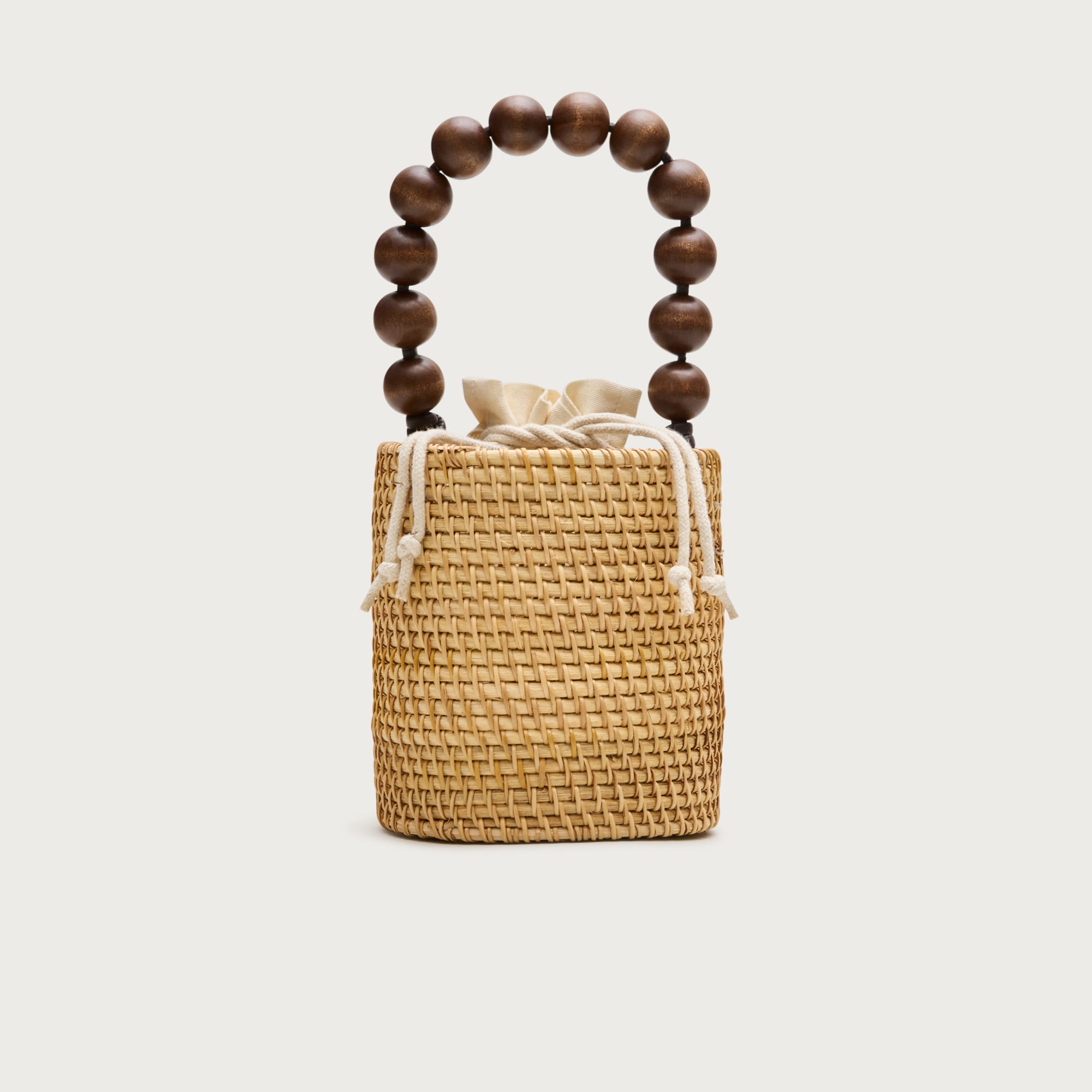 Handknotted rattan bucket bag with wood beads
