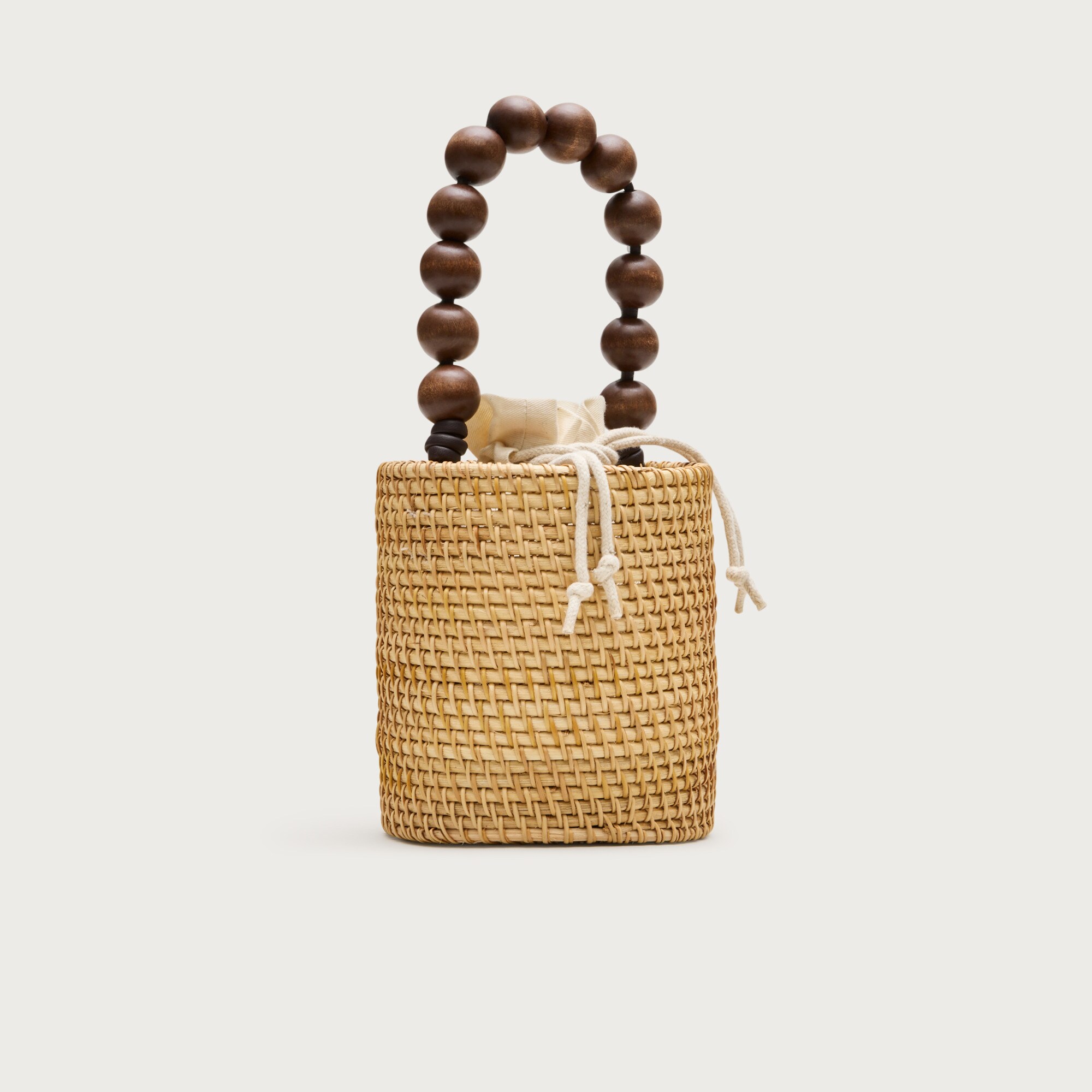 Handknotted rattan bucket bag with wood beads