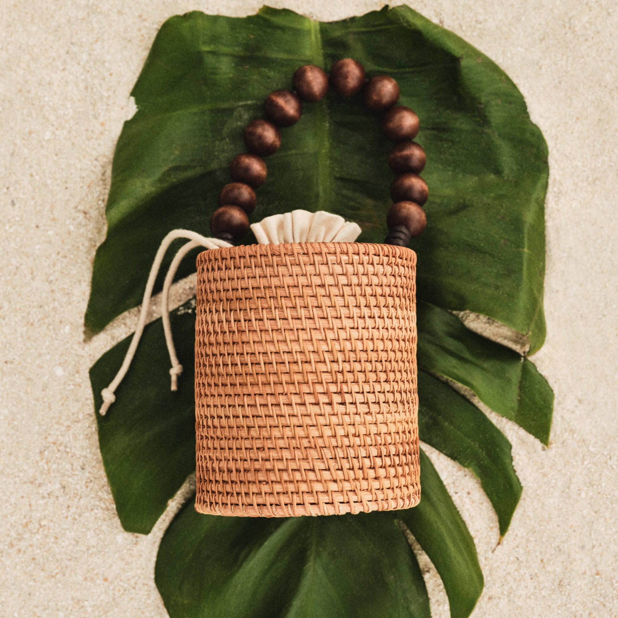 Handknotted rattan bucket bag with wood beads