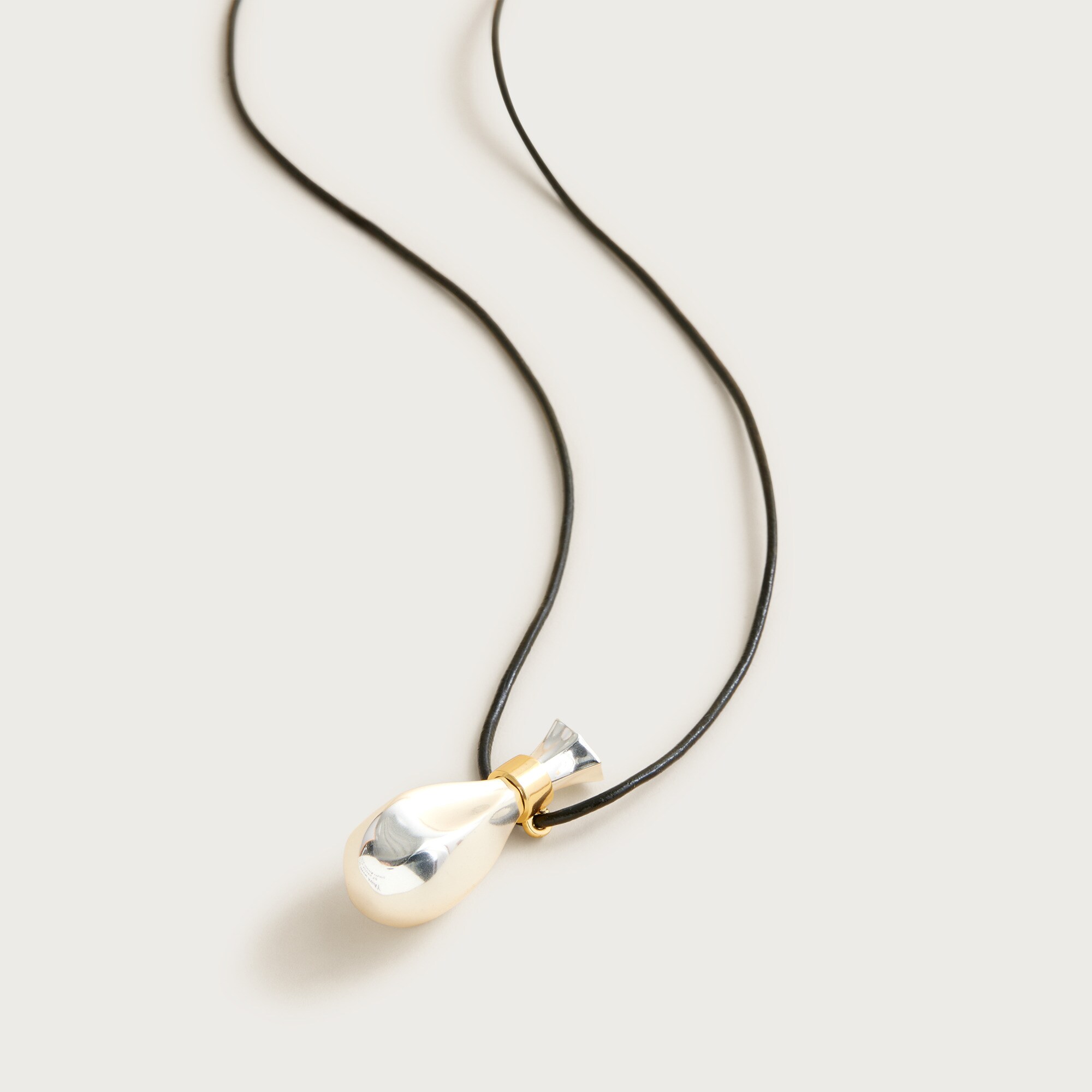 Metallic pendant necklace with leather cord