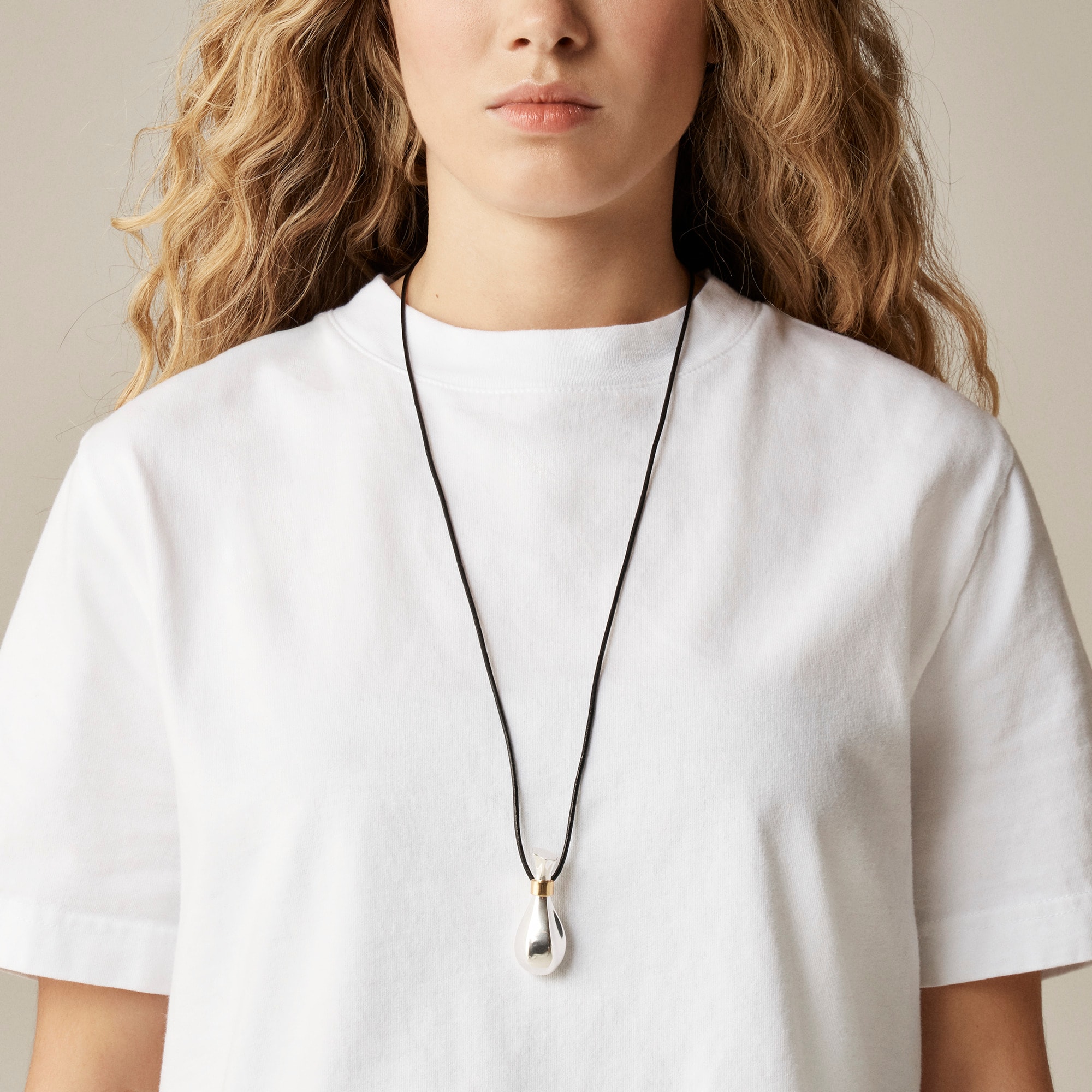 Metallic pendant necklace with leather cord