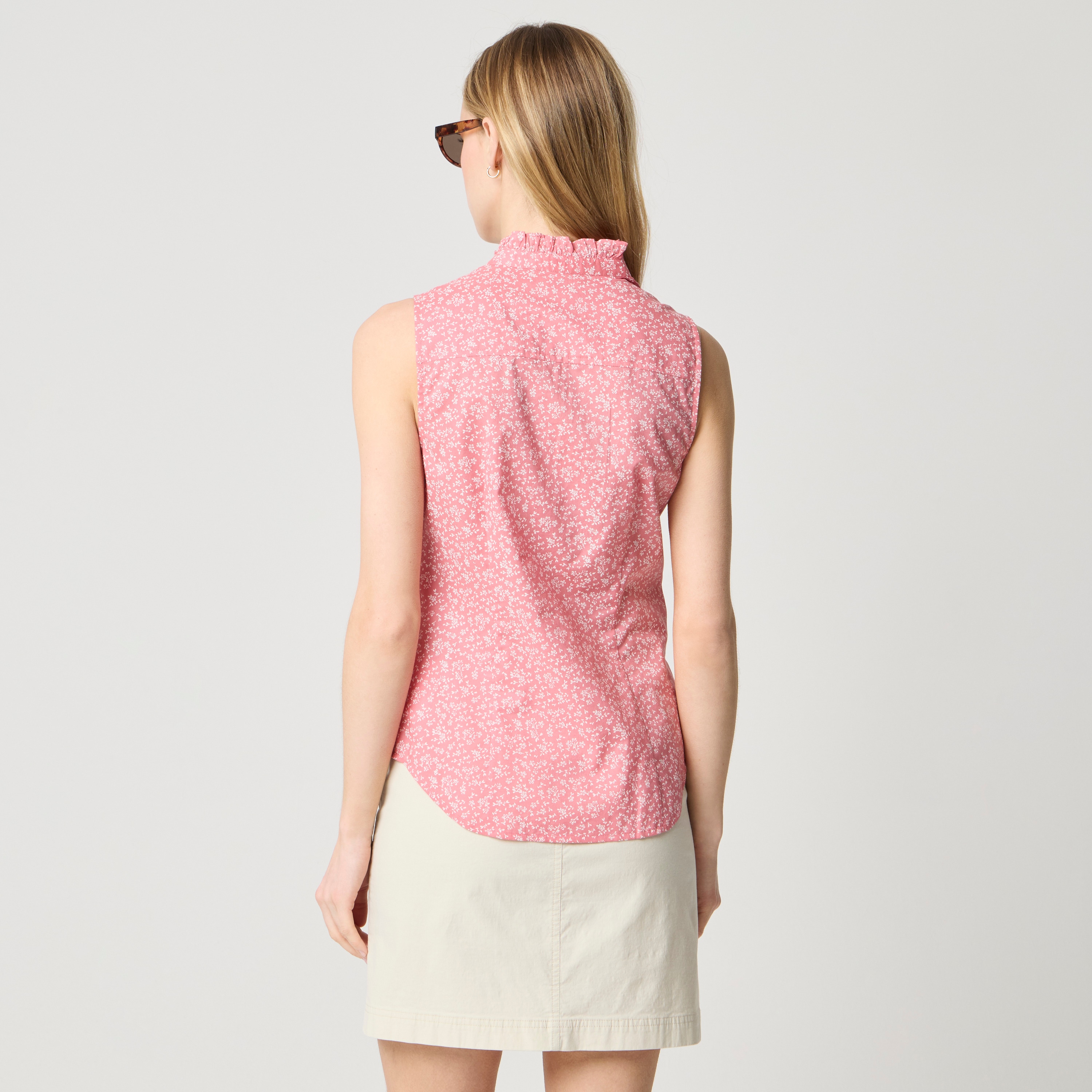 Sleeveless ruffle-front button-up shirt